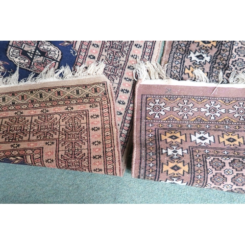 12 - A lot comprising a small dark blue ground Bokhara style rug, 100cm long x 44cm deep and another beig... 