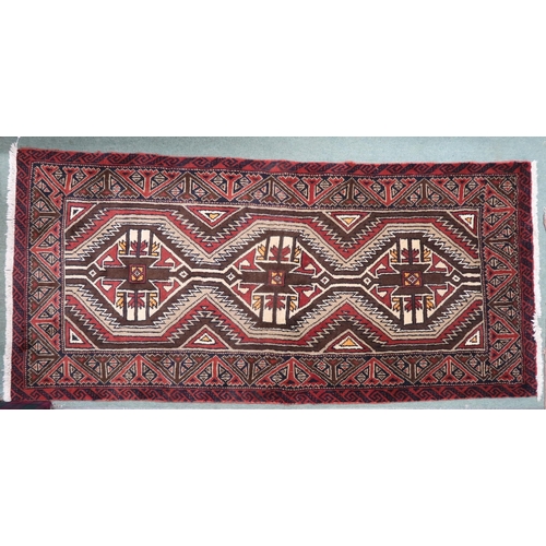 21 - A multicoloured ground fine handwoven Persian Baluchi nomadic rug with geometric patterned ground wi... 