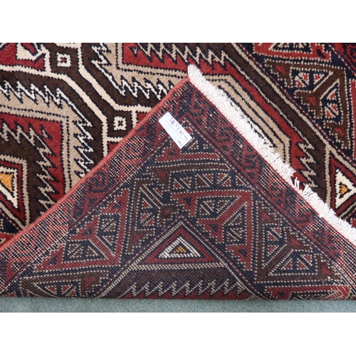 21 - A multicoloured ground fine handwoven Persian Baluchi nomadic rug with geometric patterned ground wi... 