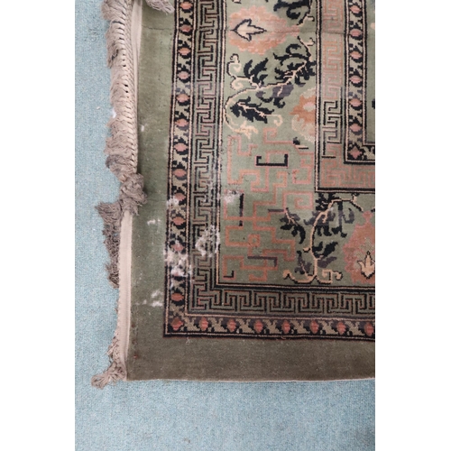 25 - A large green ground Oriental Templeton style carpet with dark circular central medallion on floral ... 