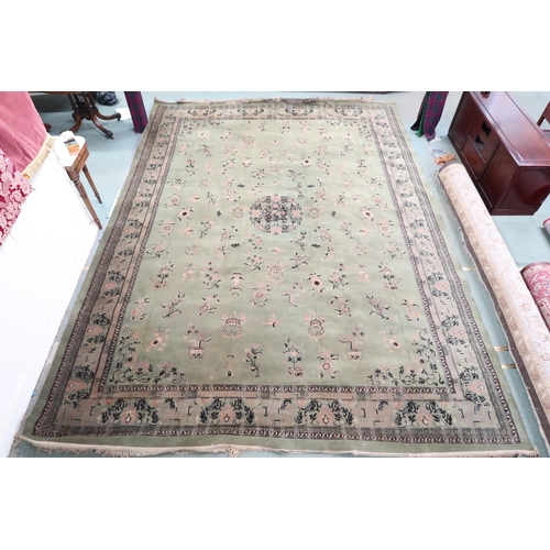 25 - A large green ground Oriental Templeton style carpet with dark circular central medallion on floral ... 