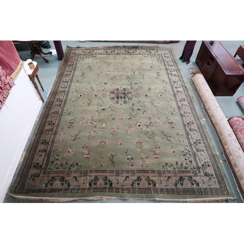 25 - A large green ground Oriental Templeton style carpet with dark circular central medallion on floral ... 