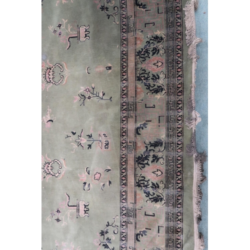 25 - A large green ground Oriental Templeton style carpet with dark circular central medallion on floral ... 