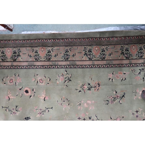 25 - A large green ground Oriental Templeton style carpet with dark circular central medallion on floral ... 