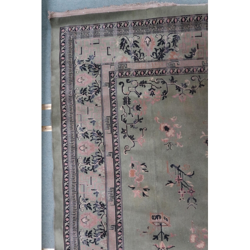 25 - A large green ground Oriental Templeton style carpet with dark circular central medallion on floral ... 