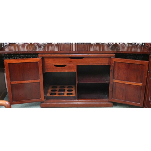 37 - A 20th century Chinese hardwood cocktail cabinet with twin hinged top over pair of cabinet doors con... 