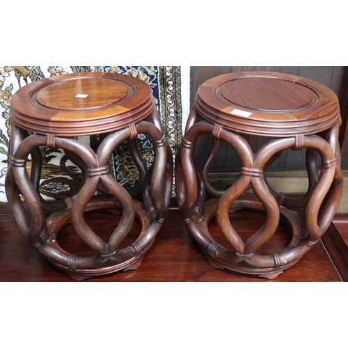 40 - A pair of 20th century Chinese hardwood with circular tops on faux bentwood sides on circular bases,... 