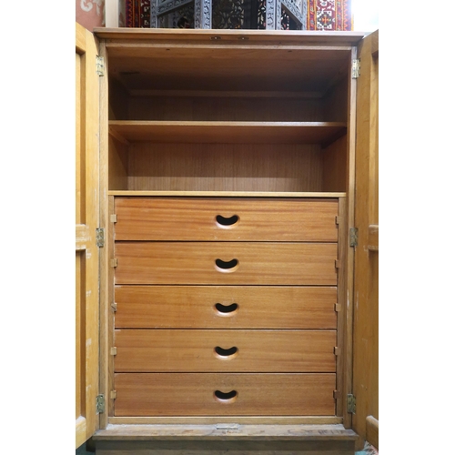 63 - An early 20th century oak Wylie & Lochhead Art Deco style two door cabinet with fruit on the vin... 