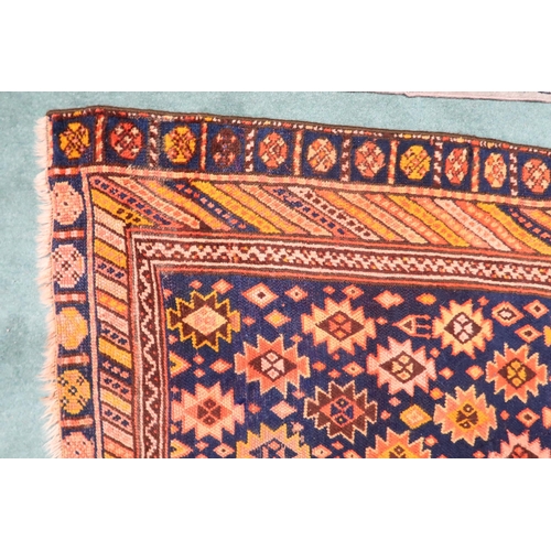 65 - A dark blue ground Persian Qashqai rug with burnt orange geometric pattern within burnt orange borde... 