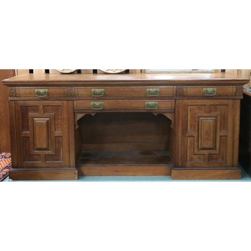 67 - A Victorian oak inverted breakfront sideboard with two central drawers over open compartment flanked... 