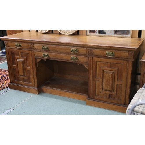 67 - A Victorian oak inverted breakfront sideboard with two central drawers over open compartment flanked... 