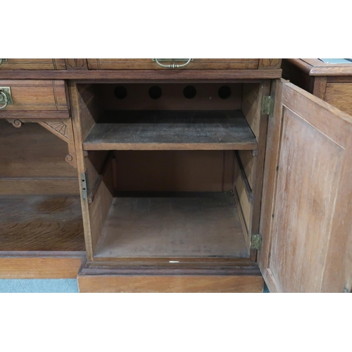 67 - A Victorian oak inverted breakfront sideboard with two central drawers over open compartment flanked... 