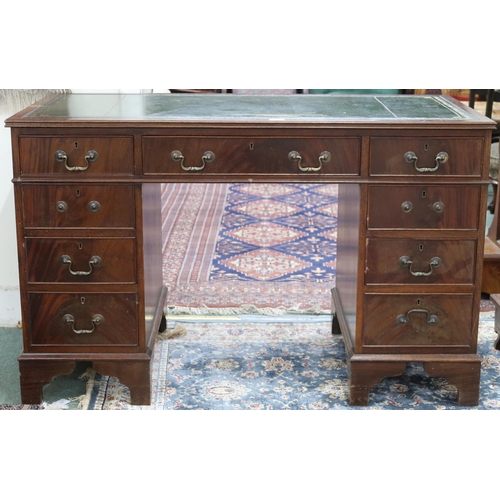 73 - A 20th century mahogany veneered pedestal writing desk with embossed skiver over long central drawer... 