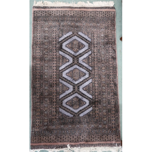 74 - A mauve ground Persian style rug with geometric diamond medallions within multiple borders, 155cm lo... 