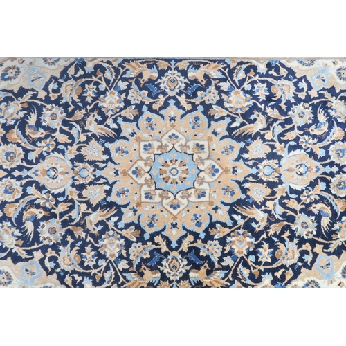 8 - A dark blue ground Keshan with beige sunburst central medallion and matching spandrels on floral/fol... 