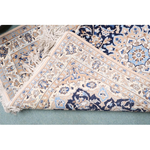 8 - A dark blue ground Keshan with beige sunburst central medallion and matching spandrels on floral/fol... 