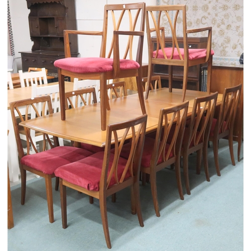 83 - A mid 20th century teak G Plan extending dining table and ten chairs, table with shaped tapering sup... 