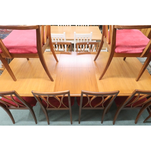 83 - A mid 20th century teak G Plan extending dining table and ten chairs, table with shaped tapering sup... 