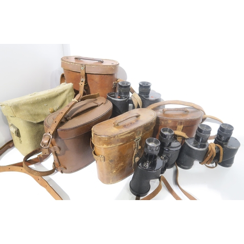 587 - A quantity of binoculars, largely military-issue, to include a pair of WW1 1918-dated No. 3 Mk. II P... 