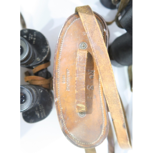 587 - A quantity of binoculars, largely military-issue, to include a pair of WW1 1918-dated No. 3 Mk. II P... 