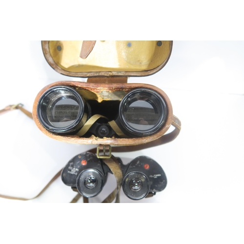 587 - A quantity of binoculars, largely military-issue, to include a pair of WW1 1918-dated No. 3 Mk. II P... 