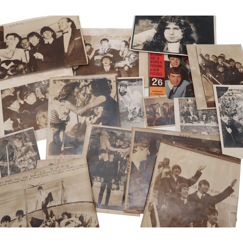 607 - A collection of Beatles press photographs, with text attached verso, largely dated 1964