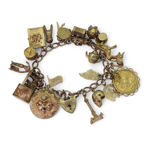 750 - A 9ct gold charm bracelet, with a 1911 full gold sovereign in 9ct pendant mount, nineteen 9ct charms... 