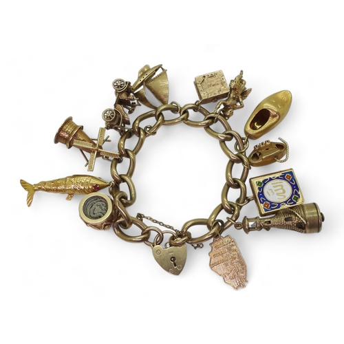 751 - A 9ct gold charm bracelet with one 18ct gold clog charm 3.8gms approx, four 14k charms to include wi... 