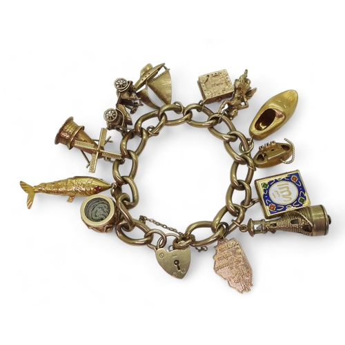 751 - A 9ct gold charm bracelet with one 18ct gold clog charm 3.8gms approx, four 14k charms to include wi... 