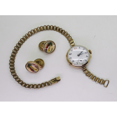 767 - A 9ct gold watch head, diameter 2.8cm, approx weight with mechanism 15.5gms with gold plated strap, ... 