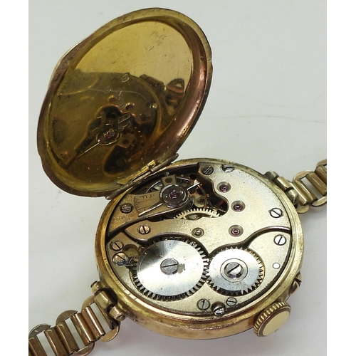 767 - A 9ct gold watch head, diameter 2.8cm, approx weight with mechanism 15.5gms with gold plated strap, ... 