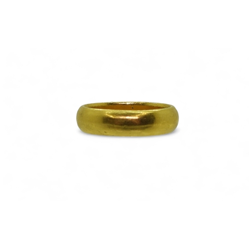 772 - A bright yellow metal wedding ring, stamped with Chinese characters, size X1/2, weight 15.2gms