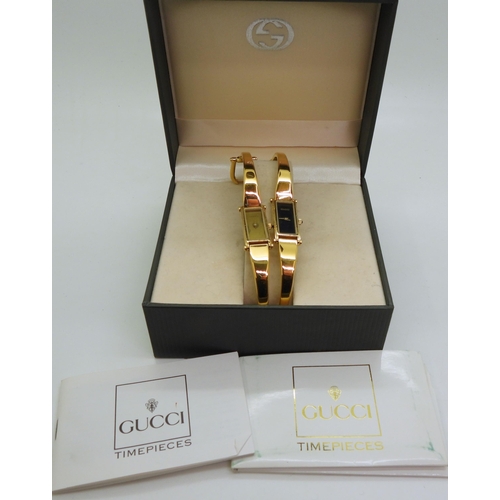 Two Gucci 1500 bangle watches, gold plated steel with a black dial ...