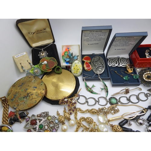 934 - A large collection of costume jewellery in a blue cargo style box, a Foxhunting pattern compact, Art... 