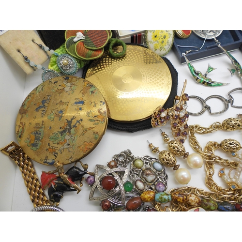 934 - A large collection of costume jewellery in a blue cargo style box, a Foxhunting pattern compact, Art... 