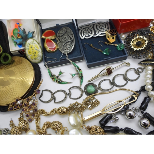 934 - A large collection of costume jewellery in a blue cargo style box, a Foxhunting pattern compact, Art... 