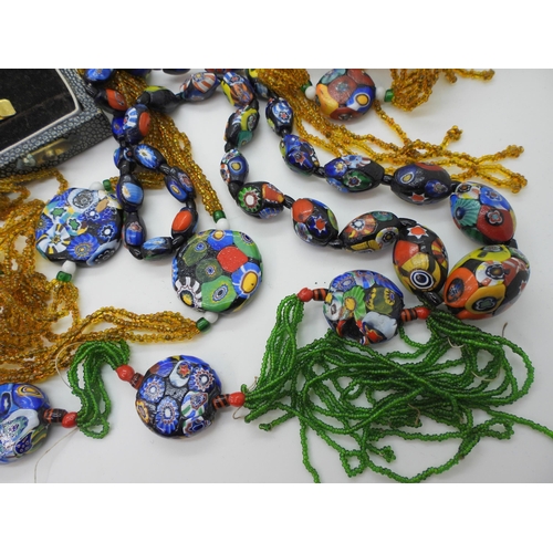 943 - Three millefiori necklaces together with a further example in need of some TLC, and a boxed set of E... 