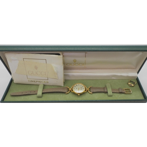 944 - A ladies gold plated Gucci watch number 6000L with serial number 0100476, with box and point of sale... 