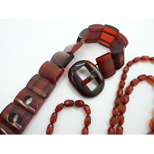 947 - A cherry amber coloured buckle bracelet, length 24.5cm, weight 39gms, together with a long string of... 