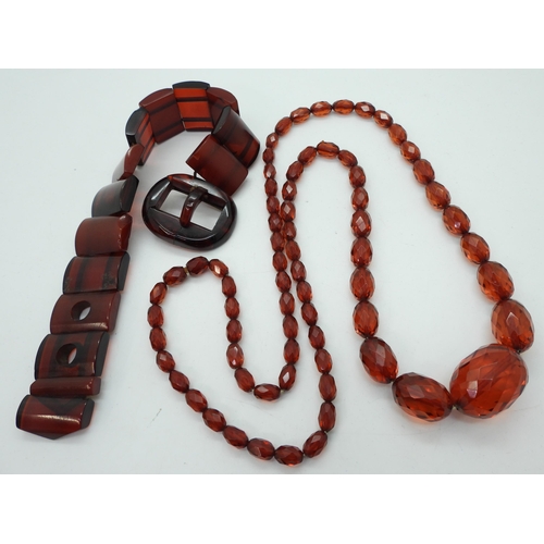 947 - A cherry amber coloured buckle bracelet, length 24.5cm, weight 39gms, together with a long string of... 