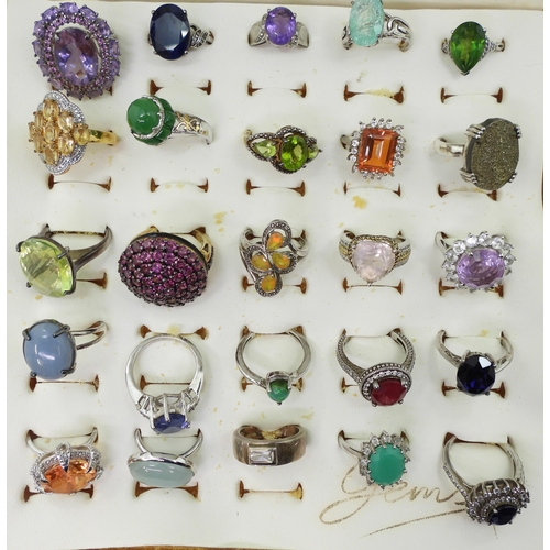 948 - Twenty two silver gem set rings to include, amethyst, treated sapphire and ruby, and a peridot three... 