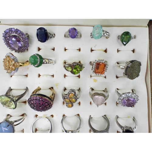 948 - Twenty two silver gem set rings to include, amethyst, treated sapphire and ruby, and a peridot three... 