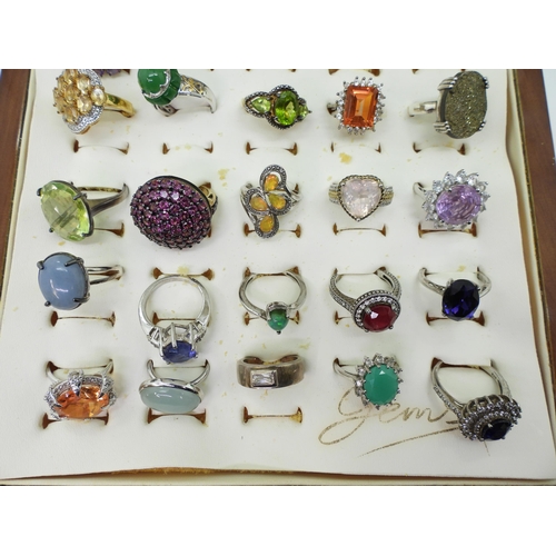 948 - Twenty two silver gem set rings to include, amethyst, treated sapphire and ruby, and a peridot three... 