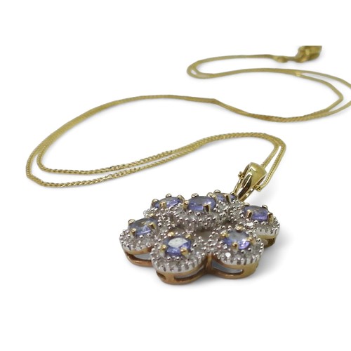 753 - A 9ct gold QVC diamond and blue gem flower pendant length of pendant with bail, 2.6cm, with a fine 4... 