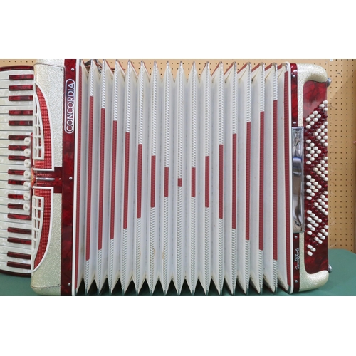 433 - An Italian Concordia Double Forte 120 bass 41 key piano accordion in red and golden glitter with cla... 