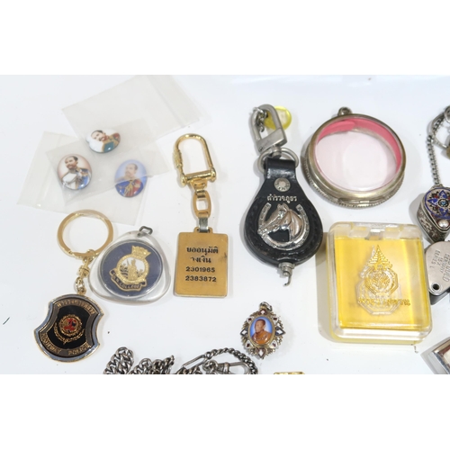 635 - A lot comprising various amulets, jewellery loops, police whistles etc