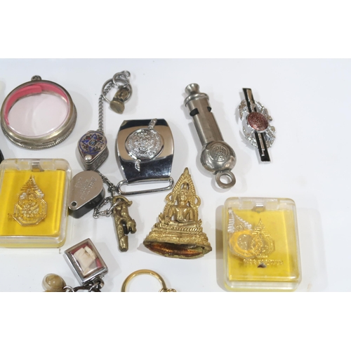 635 - A lot comprising various amulets, jewellery loops, police whistles etc