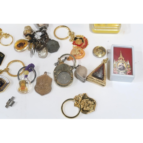 635 - A lot comprising various amulets, jewellery loops, police whistles etc