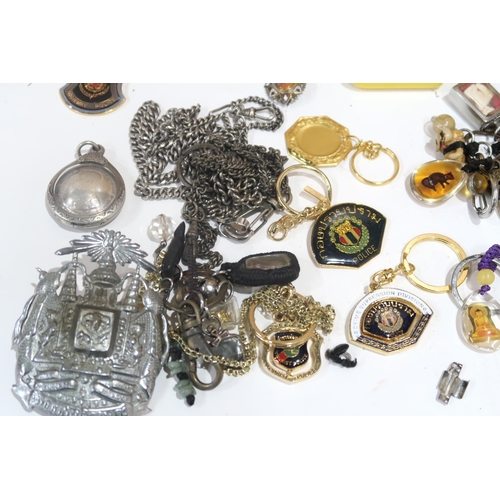 635 - A lot comprising various amulets, jewellery loops, police whistles etc