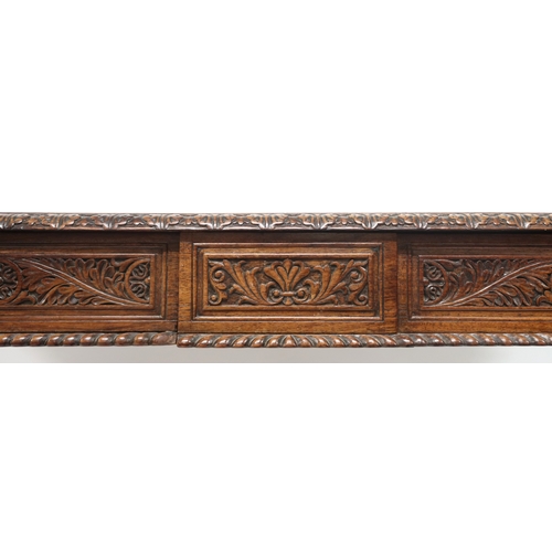 2000 - A 19TH CENTURY ANGLO-INDIAN LIBRARY TABLE rectangular top with carved foliate edges over pair of asy... 